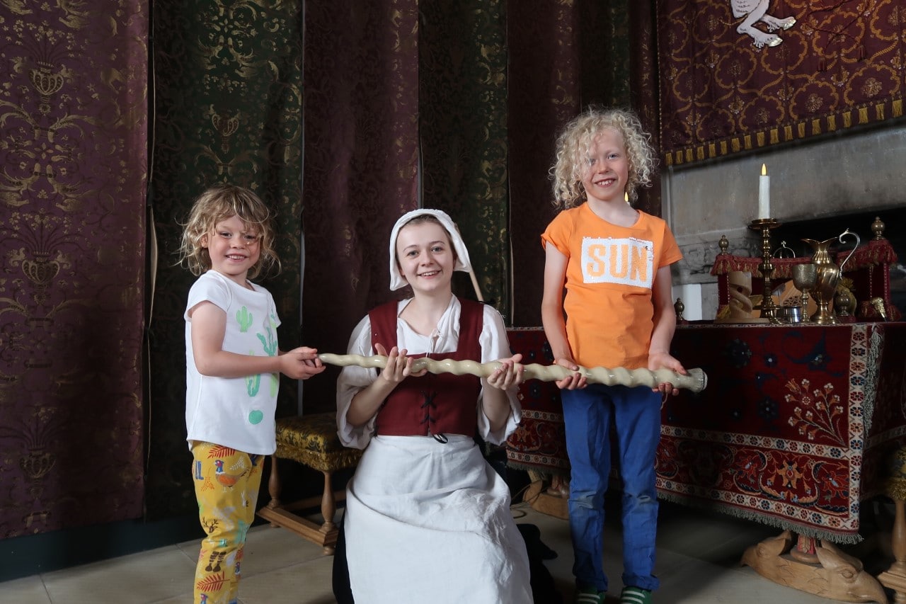 children holding a unicorn horn or narwhal horn