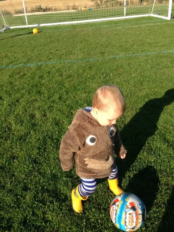 toddler playing football