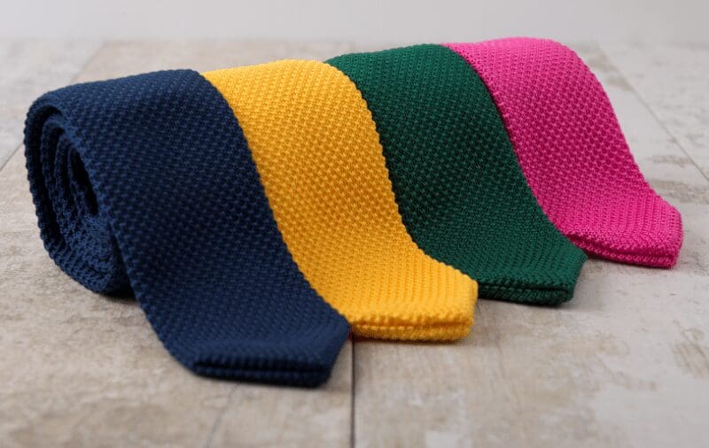 mens colourful ties in a row