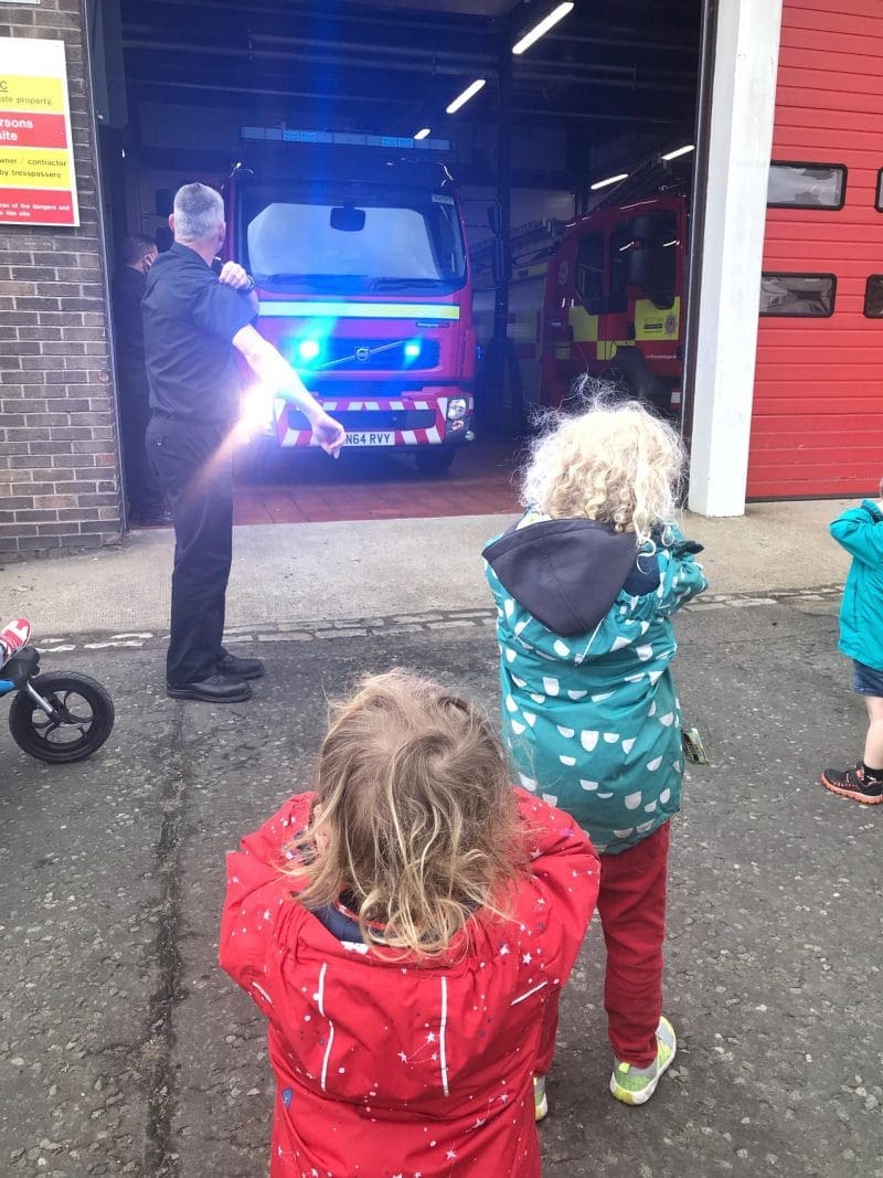 kids covering ears as the fire engine siren going off