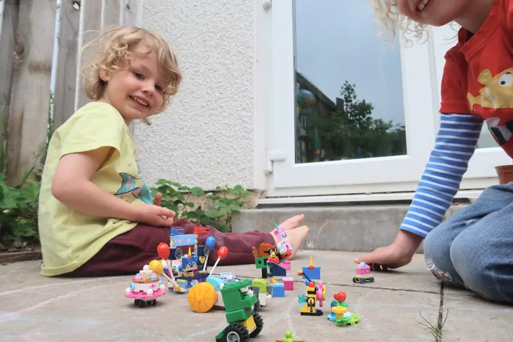 children playing with Lego in the garden