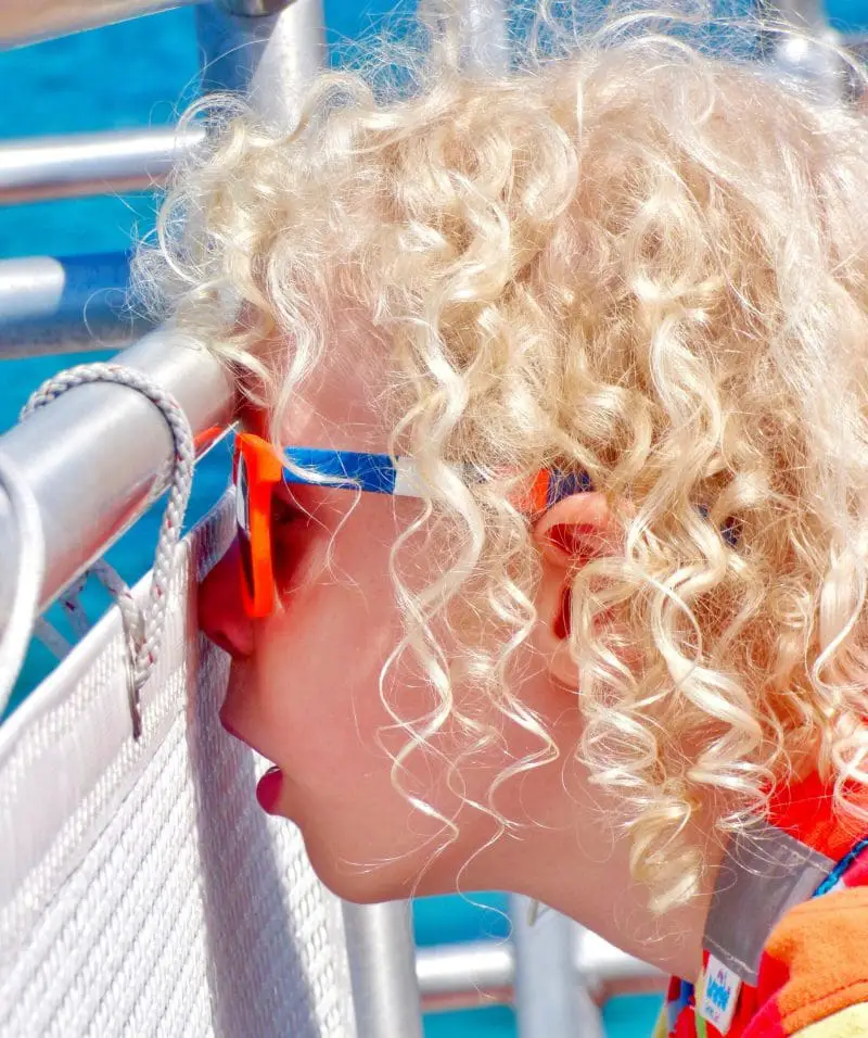 boy looking out to sea from the boat