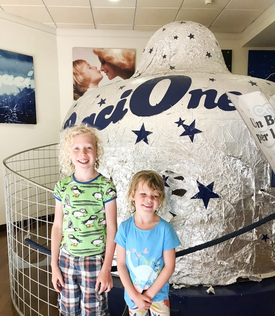 children in front of giant Baci