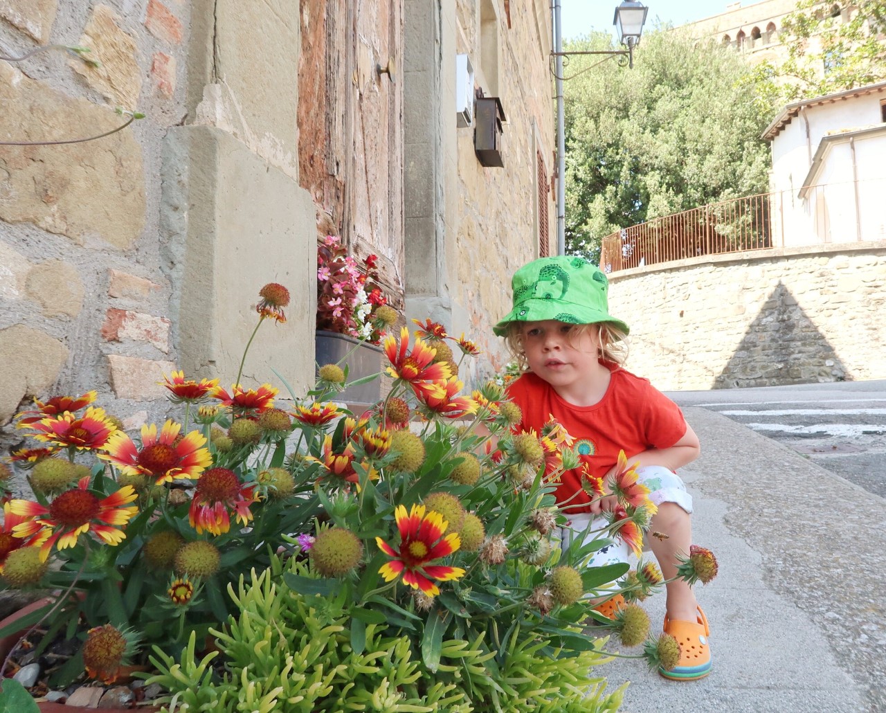 child smelling flowers