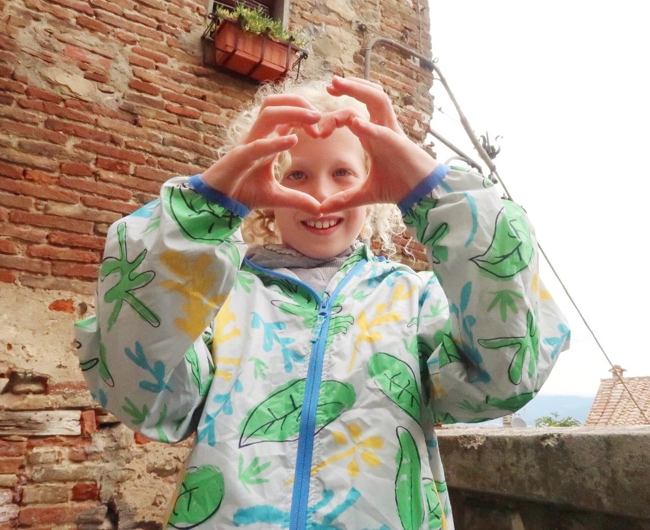 boy making heart with hands