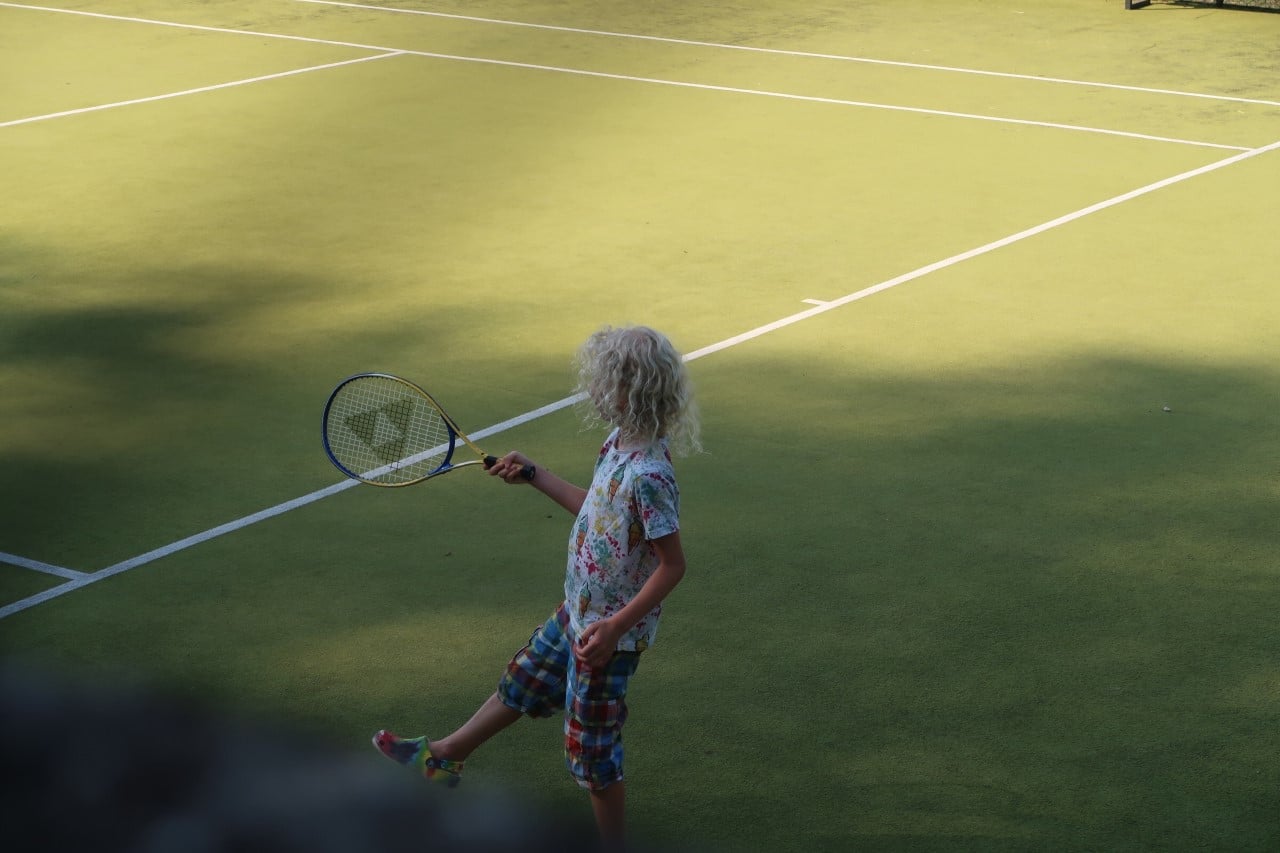 boy playing tennis