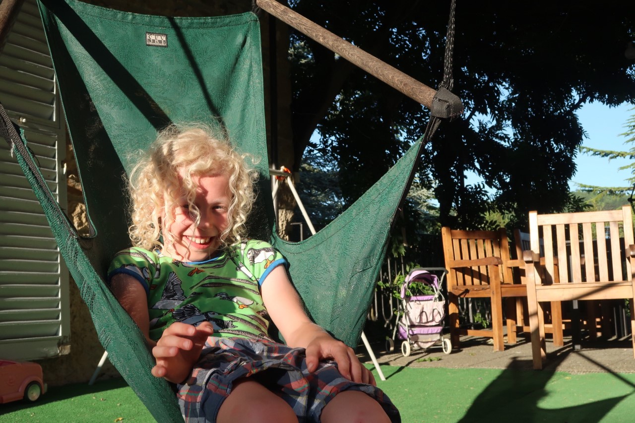 child in hammock seat