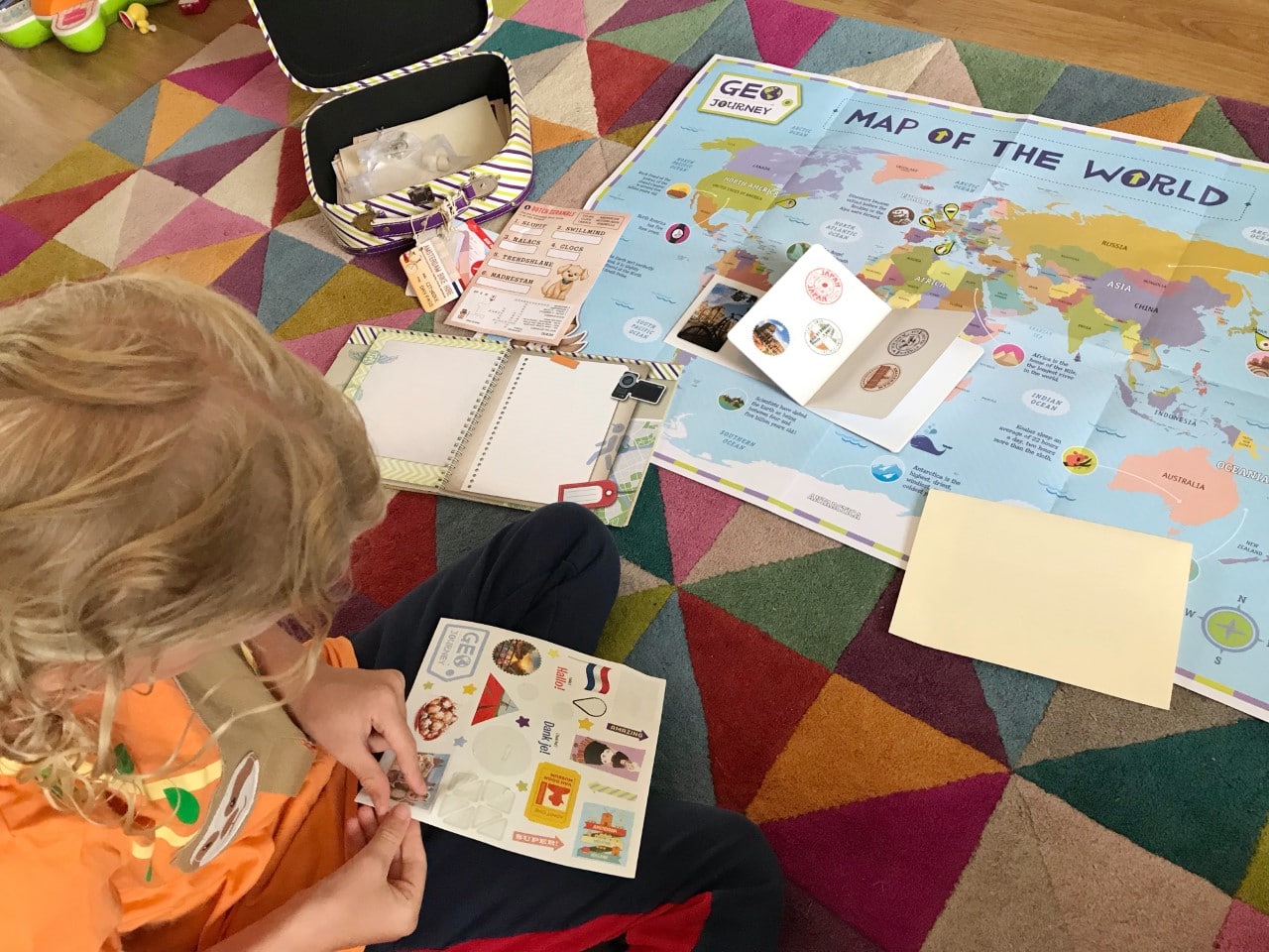 child sticking stickers in geo journey