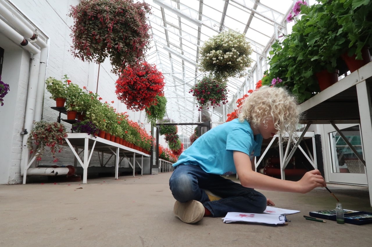 child painting in gardens