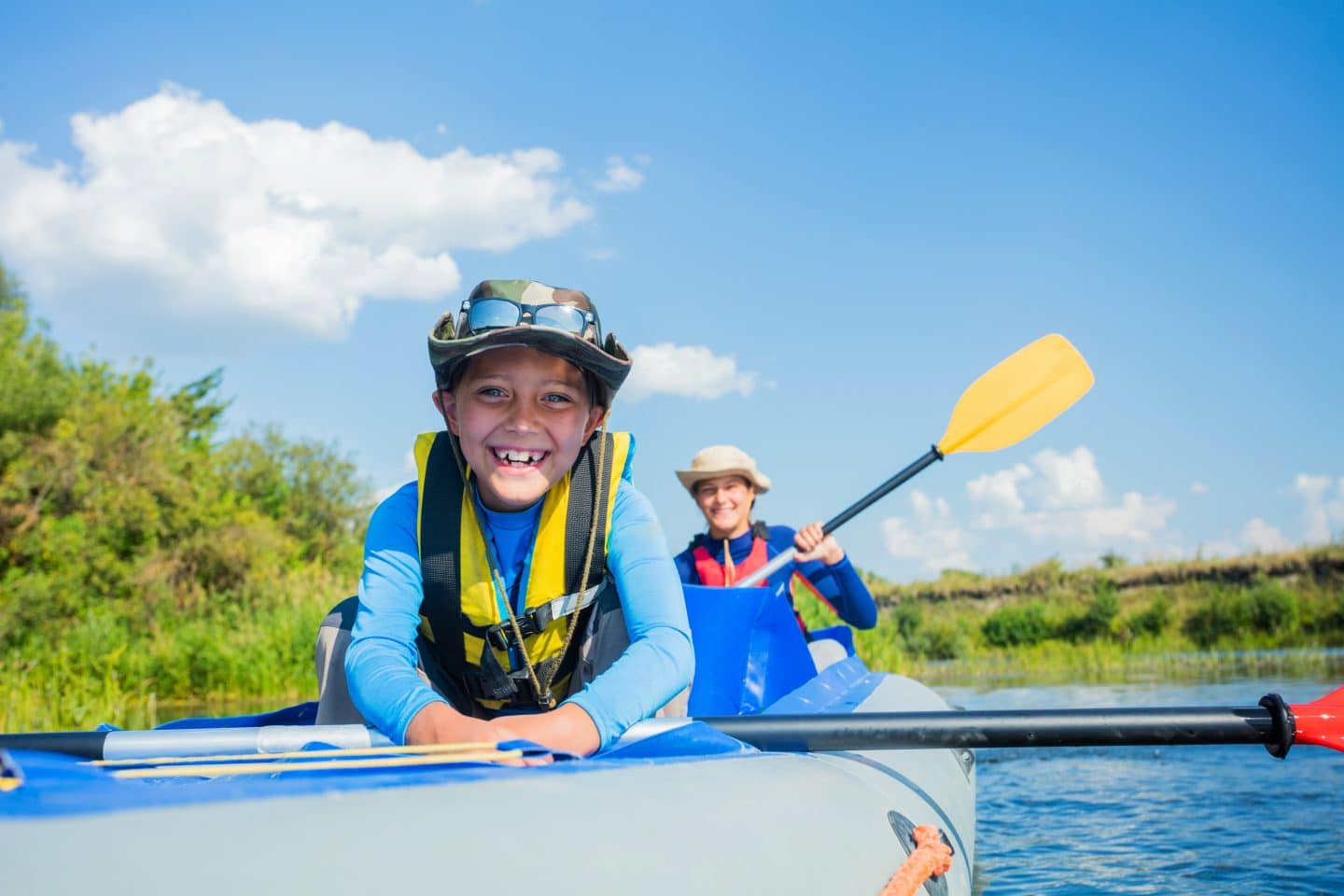 children in kayak on lake