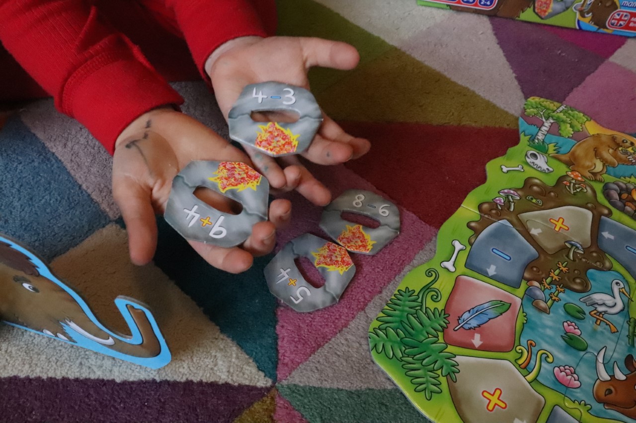 child playing board game about maths