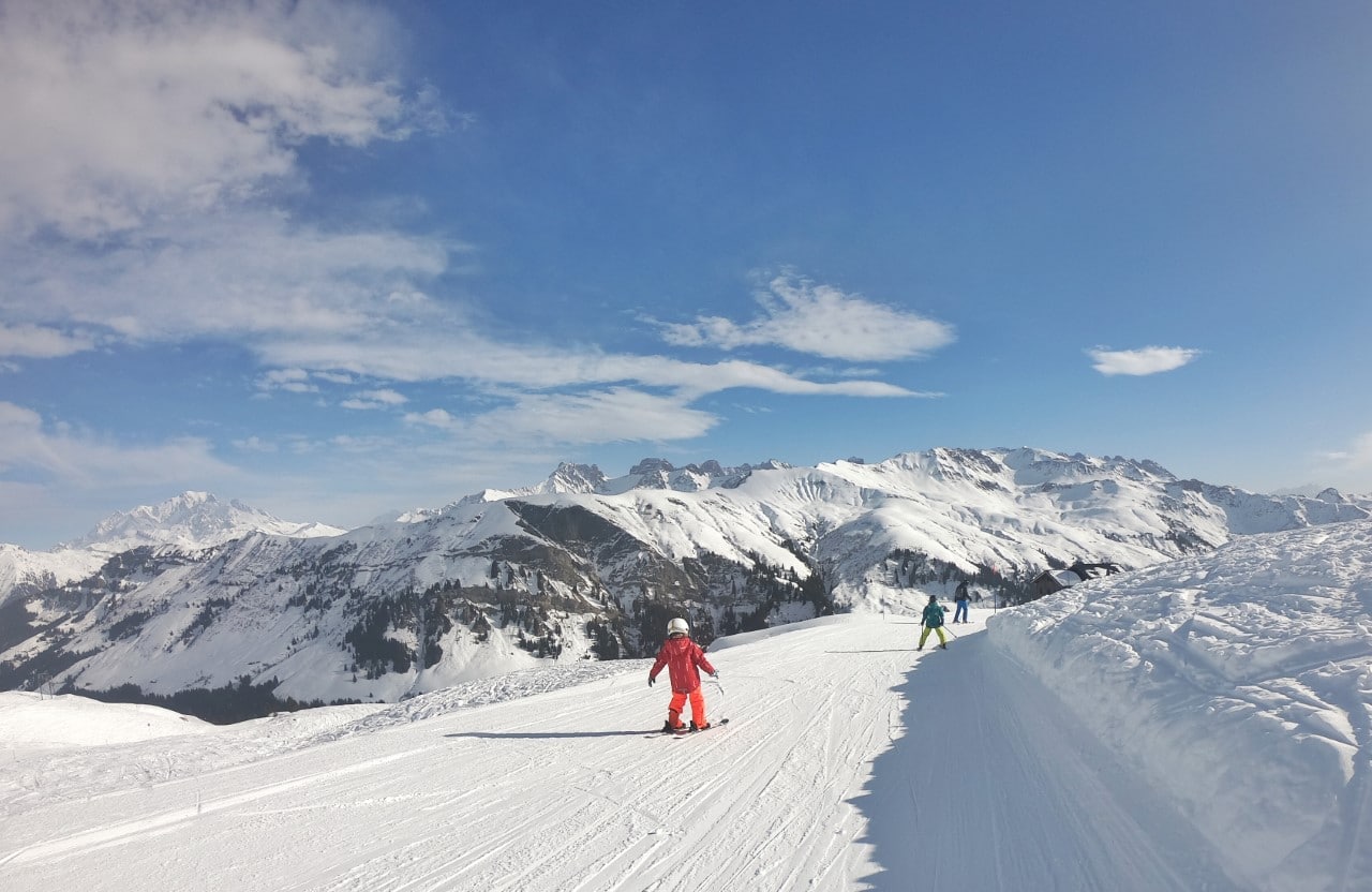 family skiing in the mountains