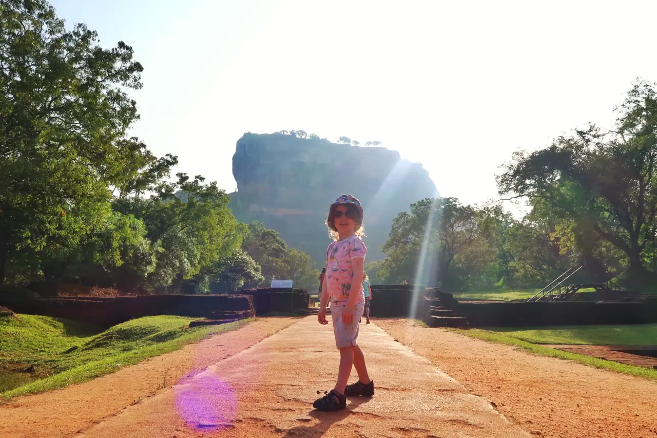 child standing in front of Sigiriya rock Sri Lanka