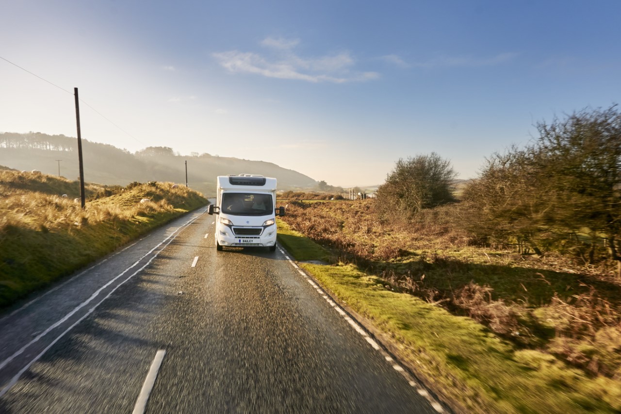 caravan driving down a road