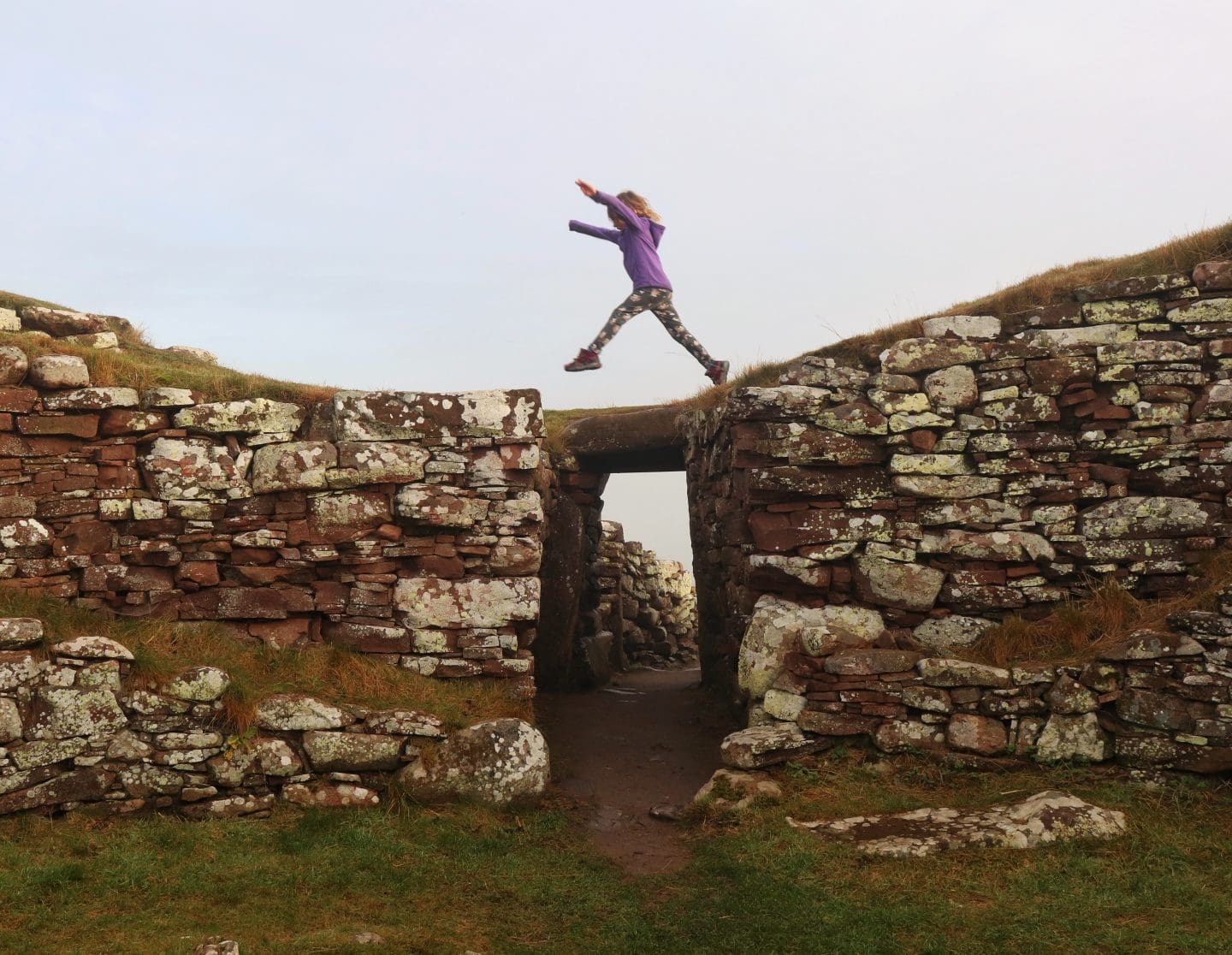 child jumping over door on broch