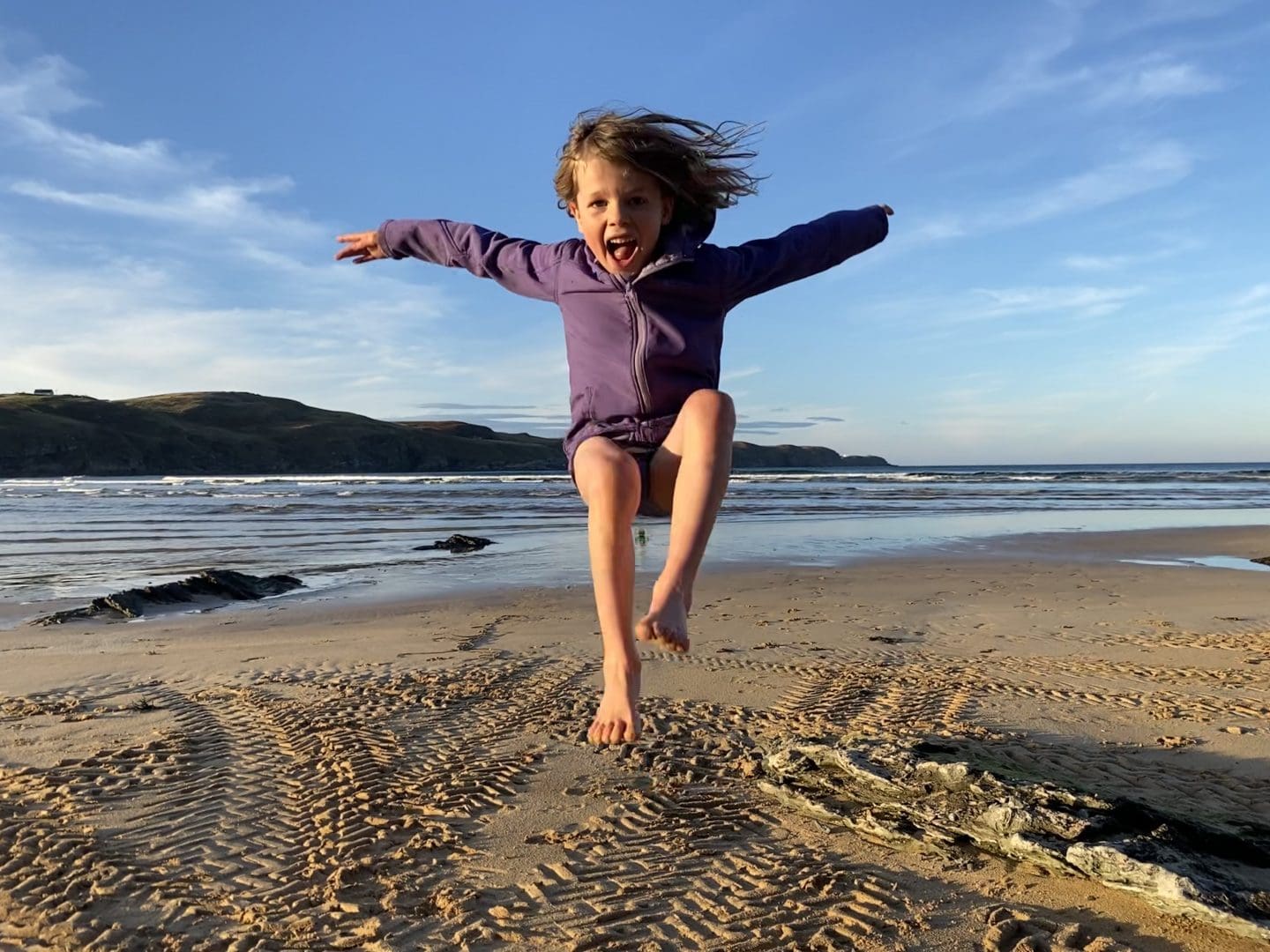 child playing at beach