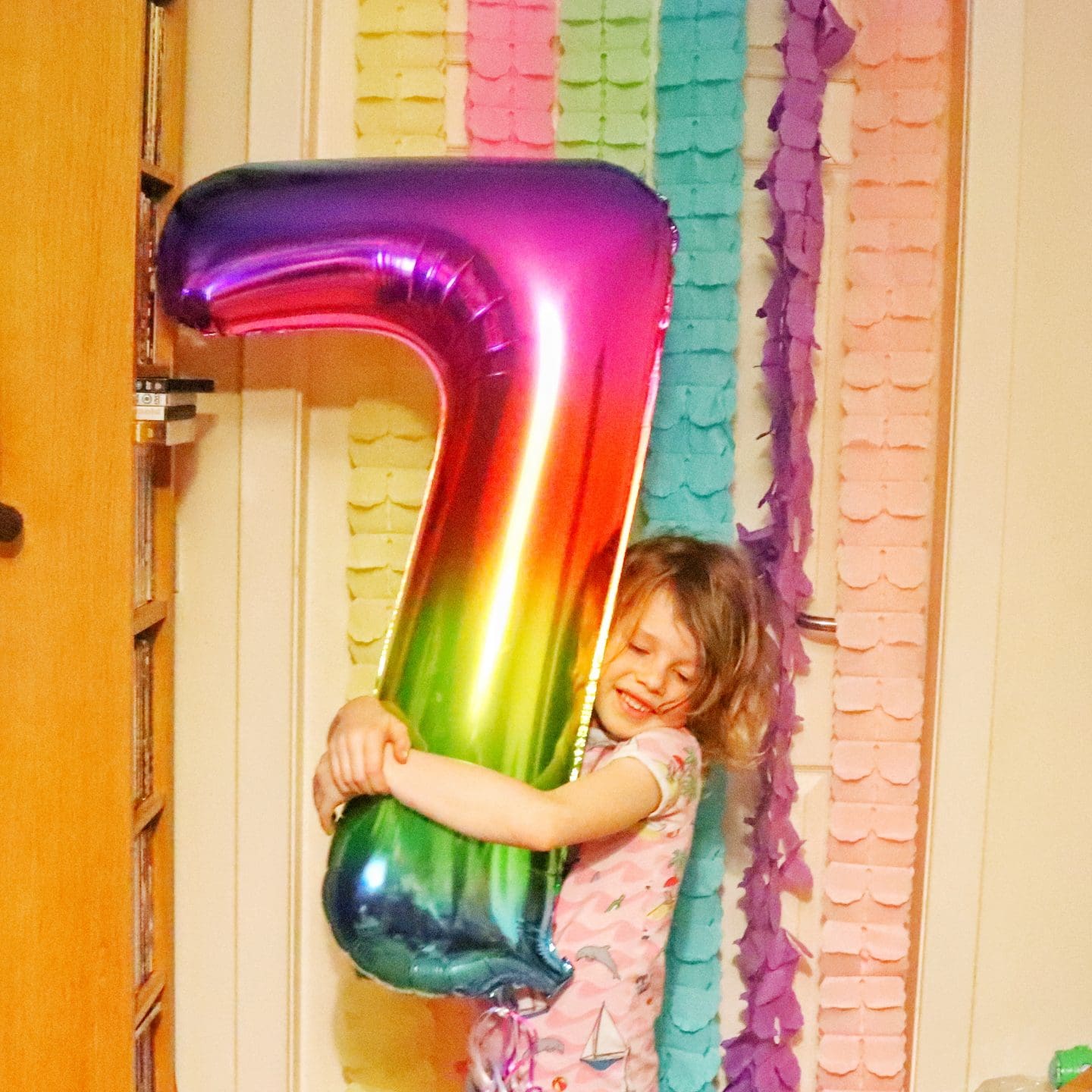 child with 7 balloon