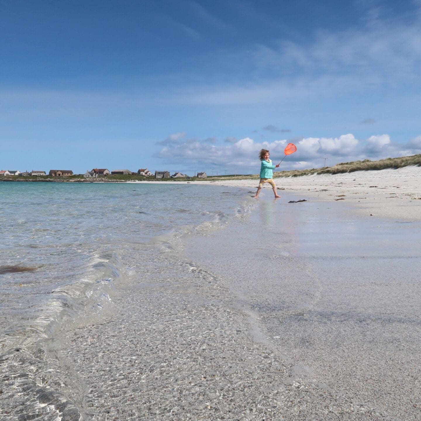 child running across the beach at Balranald Bay North Uist