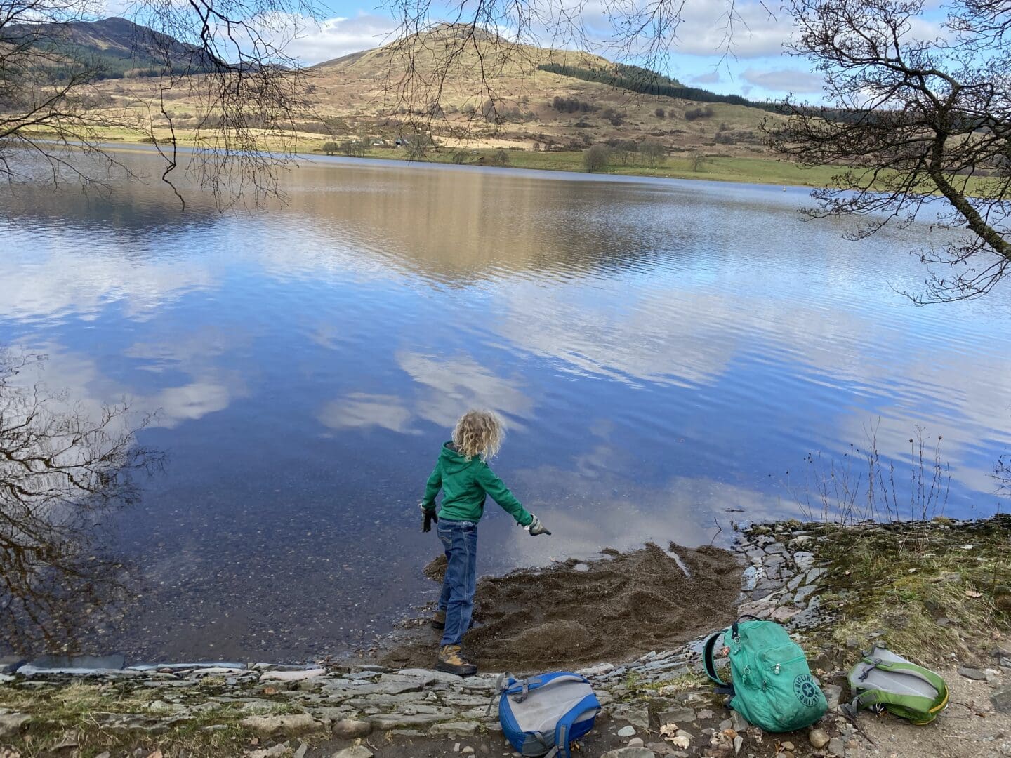 child making a medieval village out of sand beside Loch Venachar