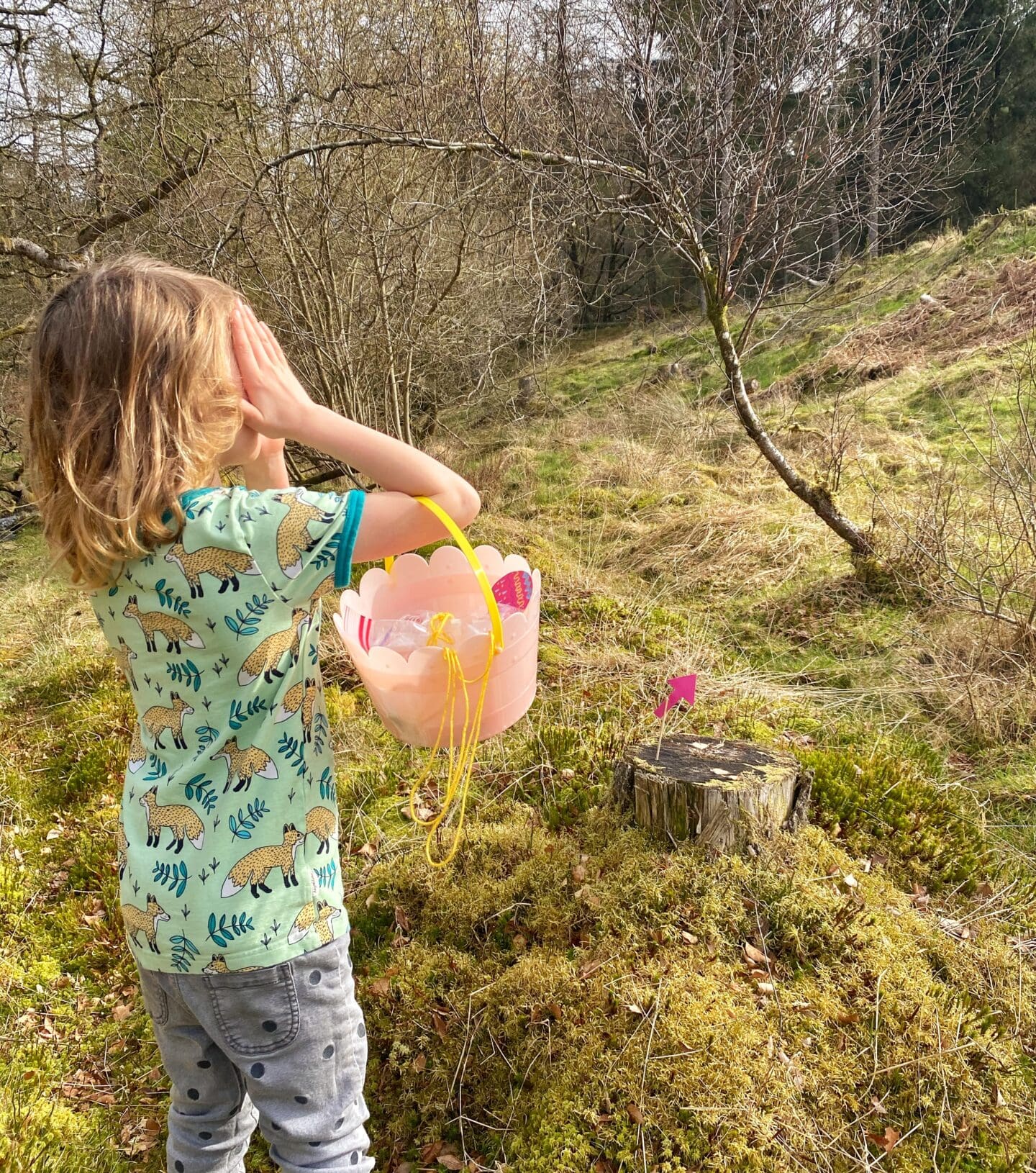child looking for easter eggs by Loch Venachar