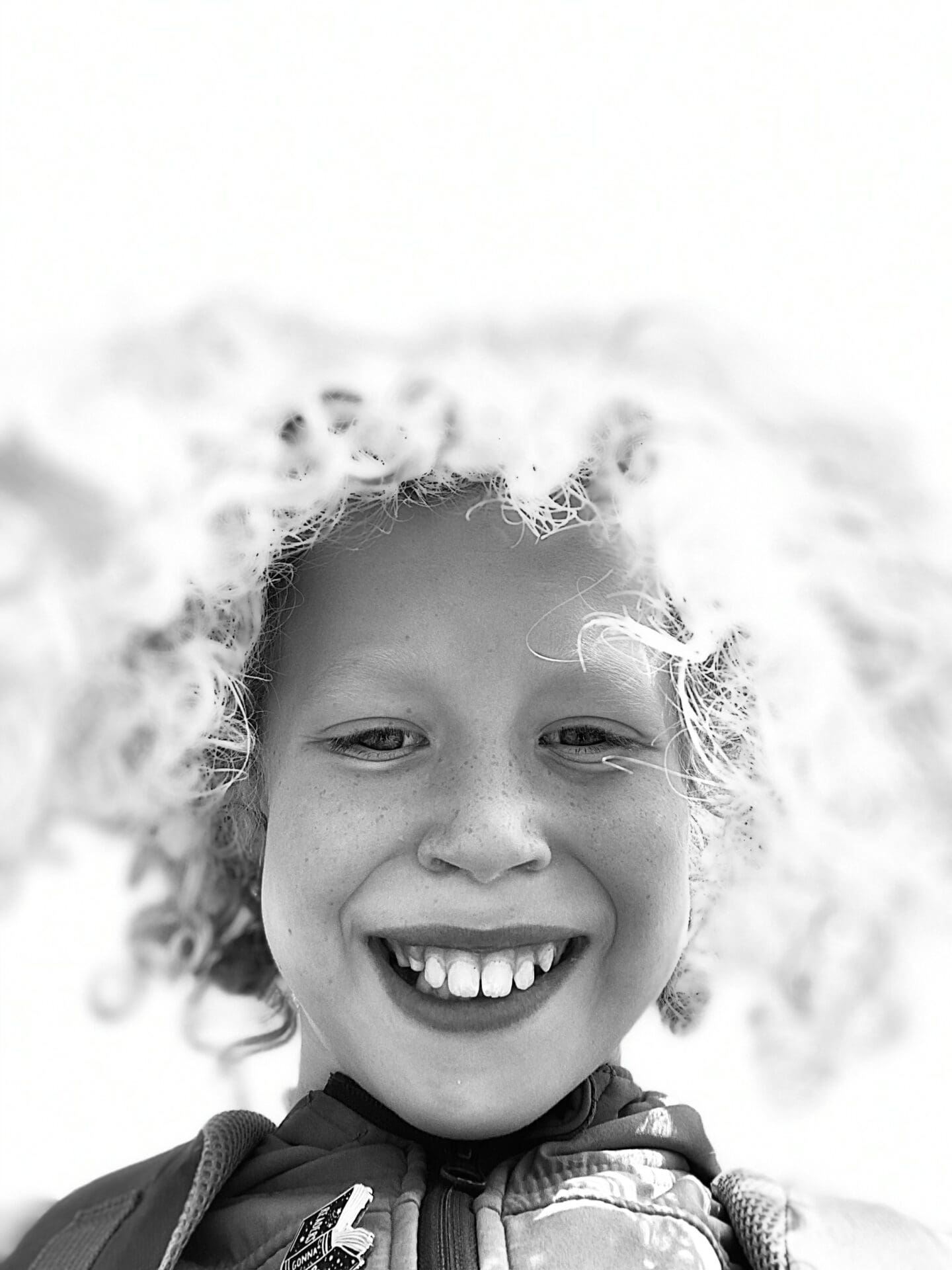 black and white photo of child with curly hair