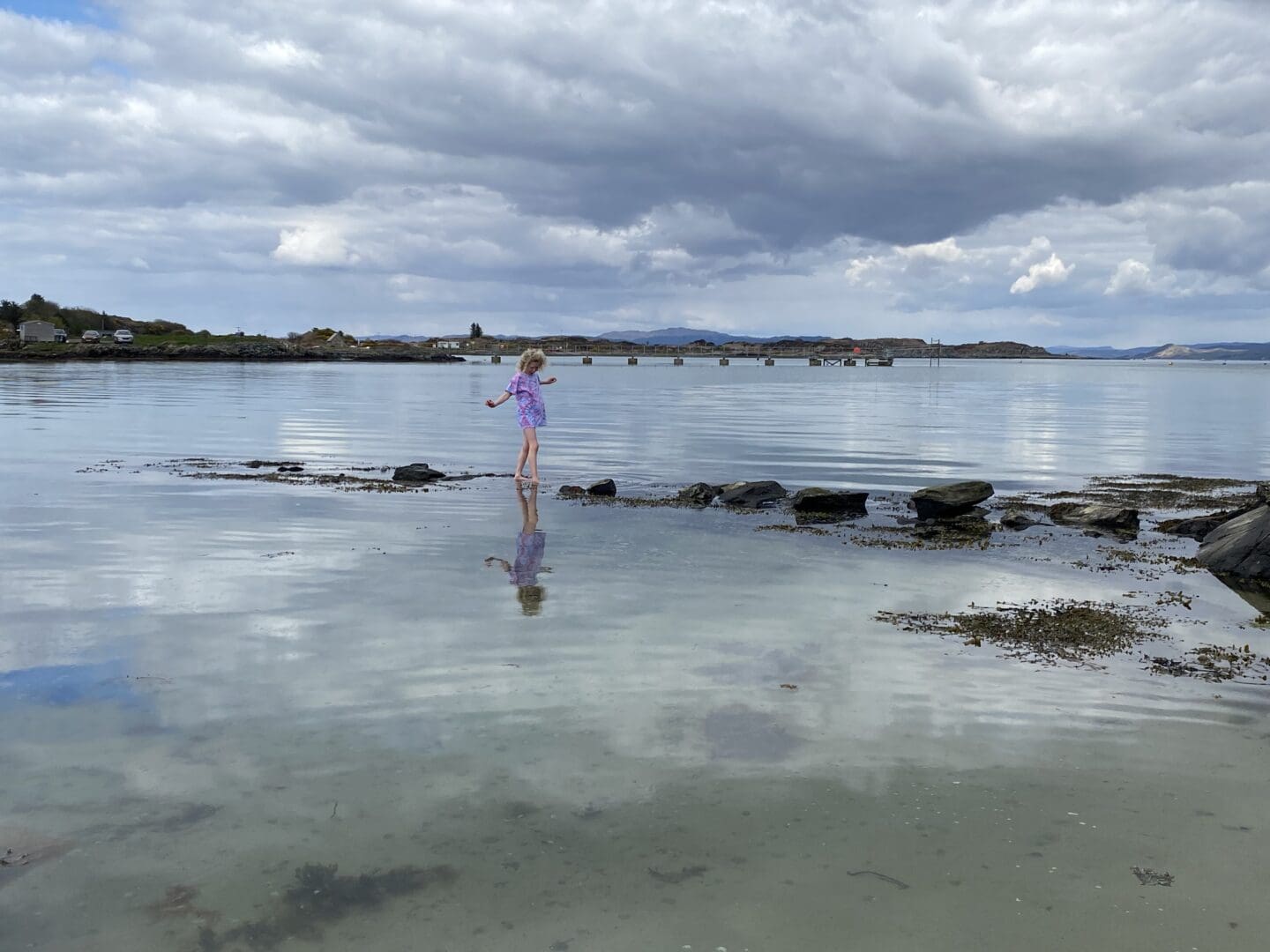 child jumping in the sea in April