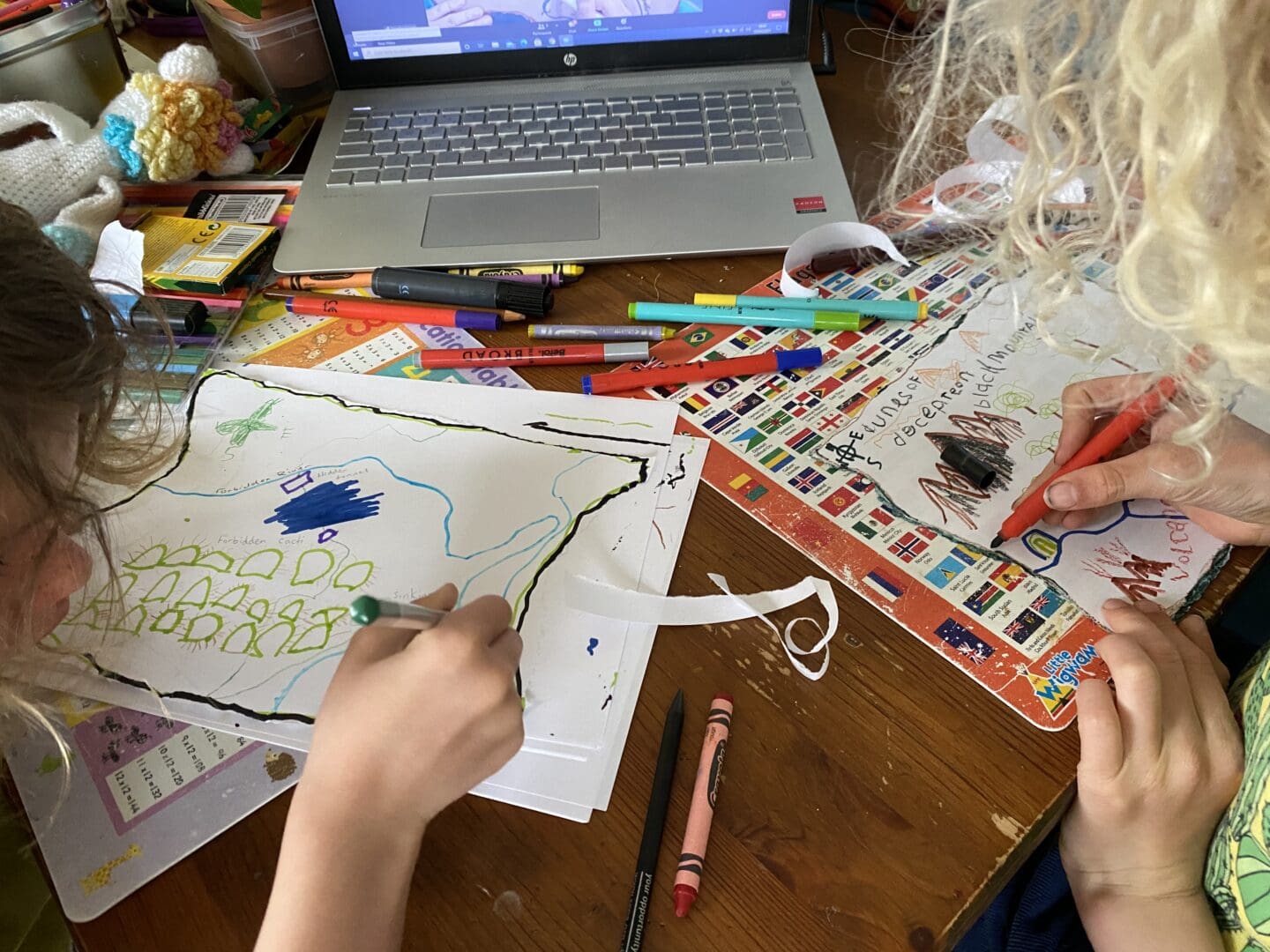 children drawing treasure maps as part of an online class