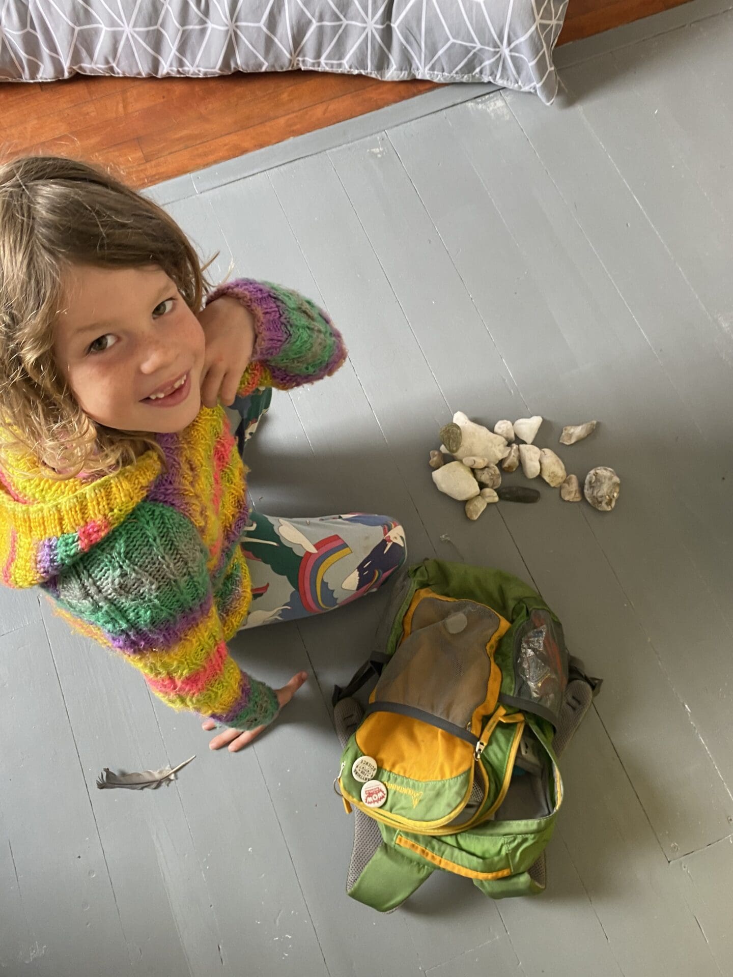 child with a collection of rocks and shells