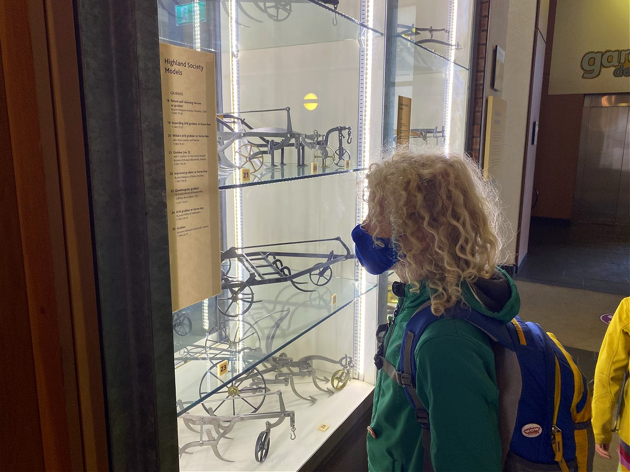 child looking at farming models in a museum