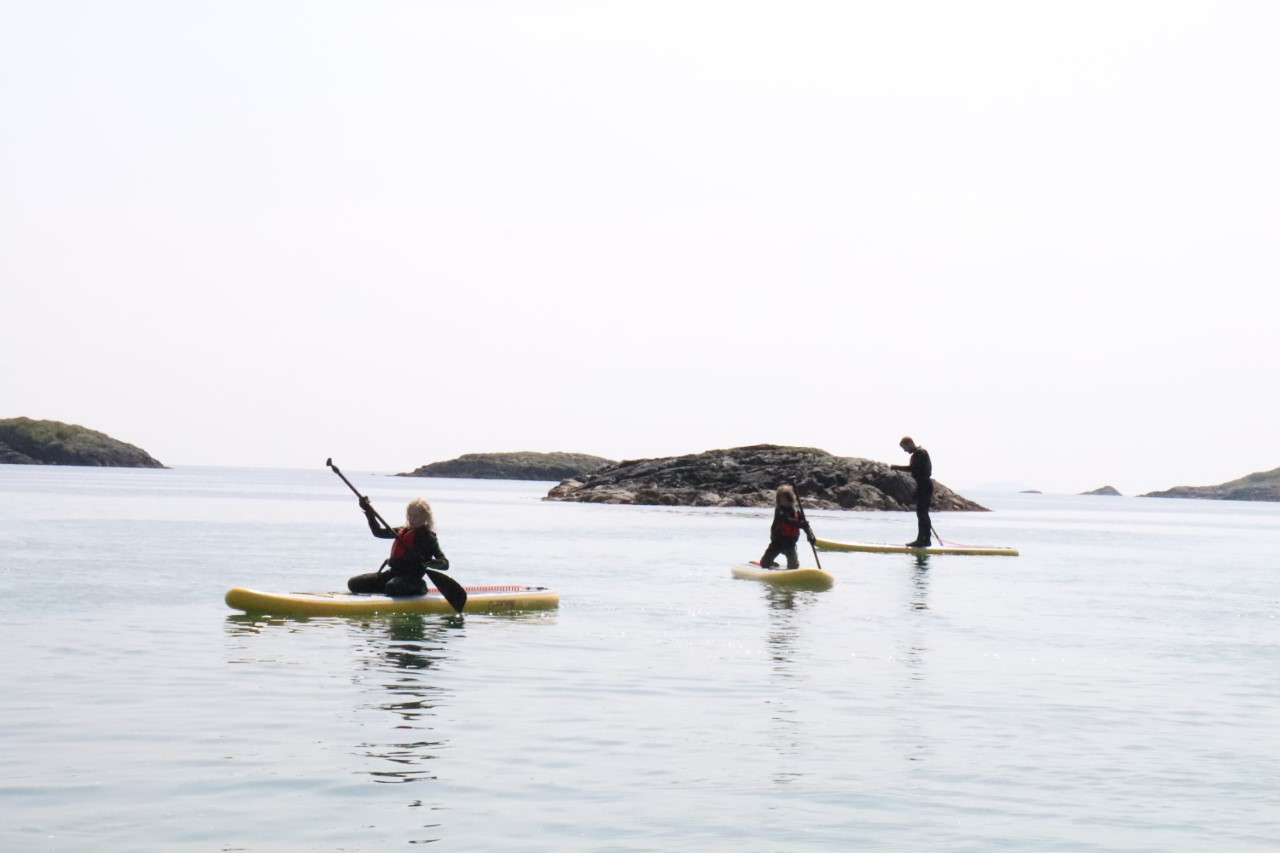 family on SUP's near Coll