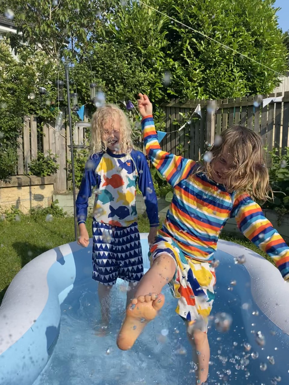 children splashing in paddling pool