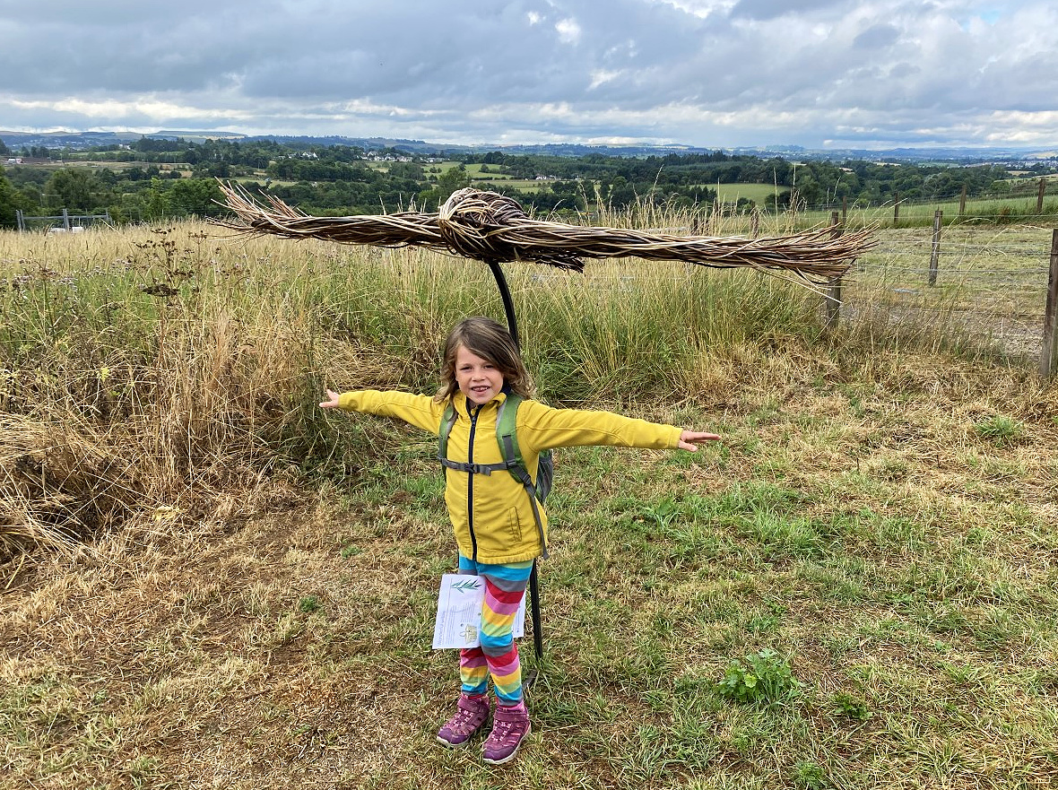 child with willow sculpture of a Buzzard