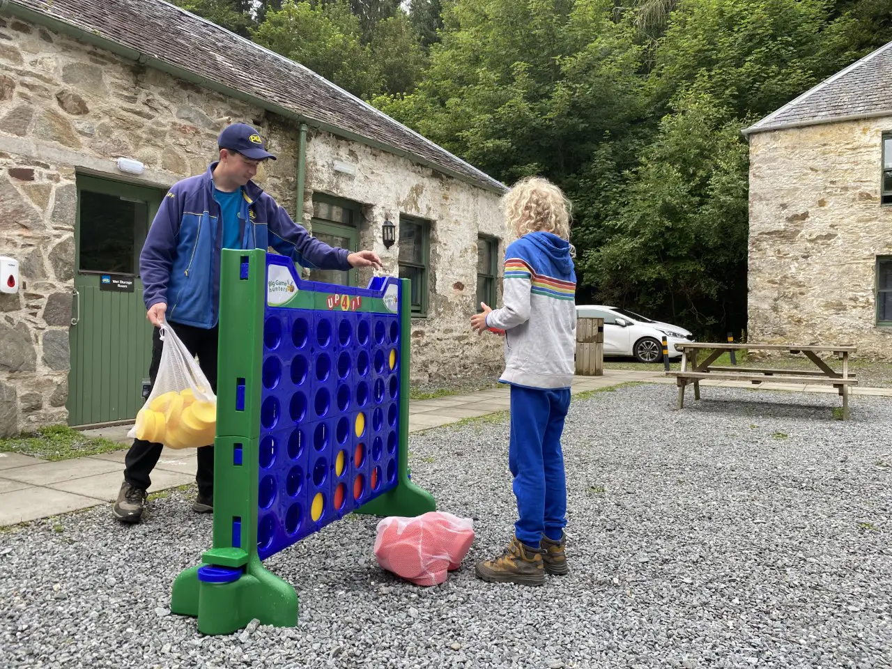 child playing connect 4 with an instructor at PGL Dalguise