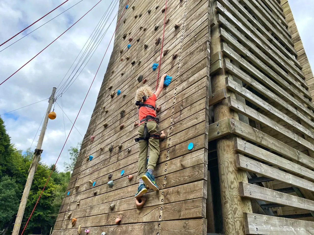 child on an outdoor climbing wall