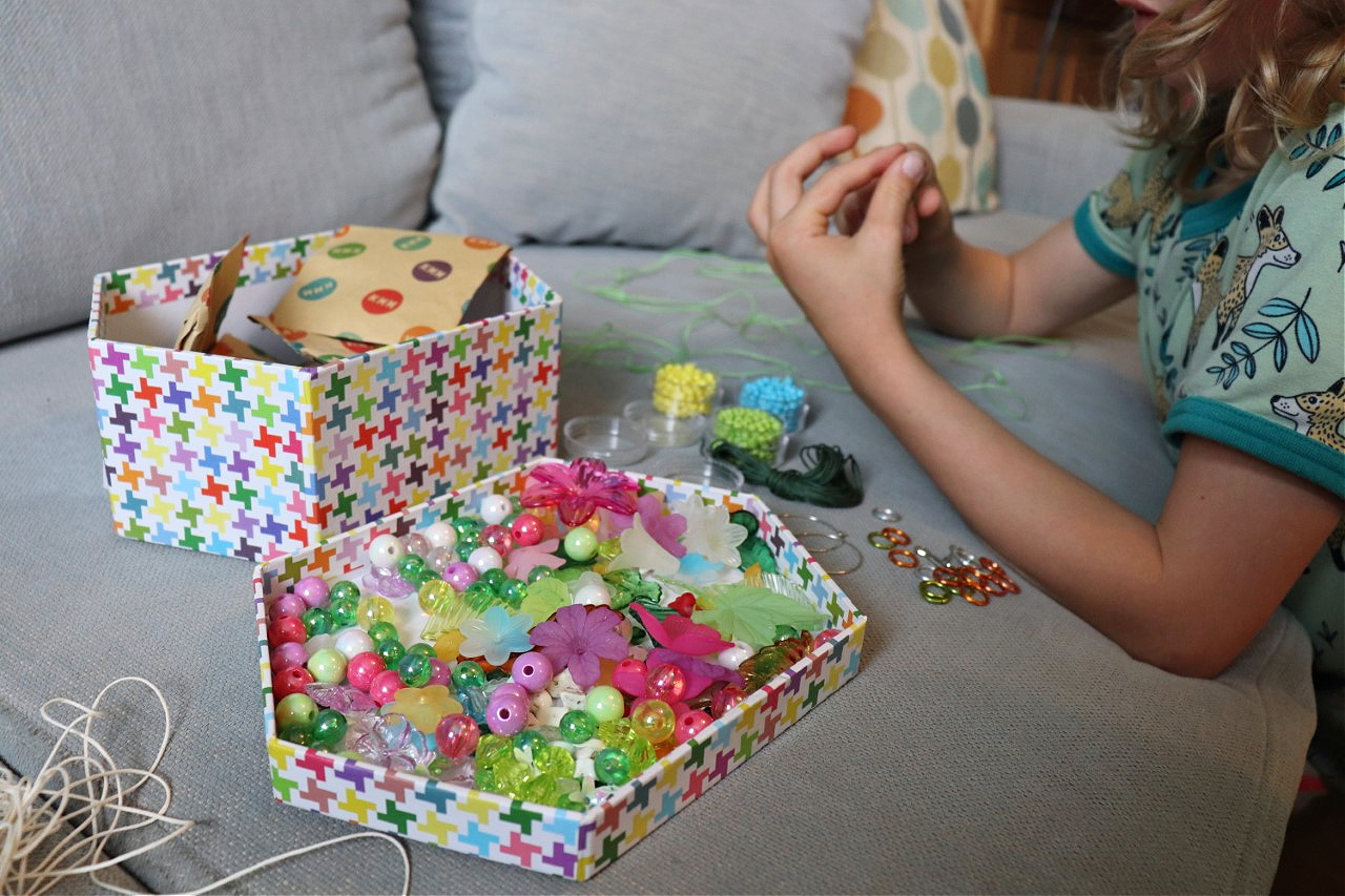 child making necklace with a jewellery kit