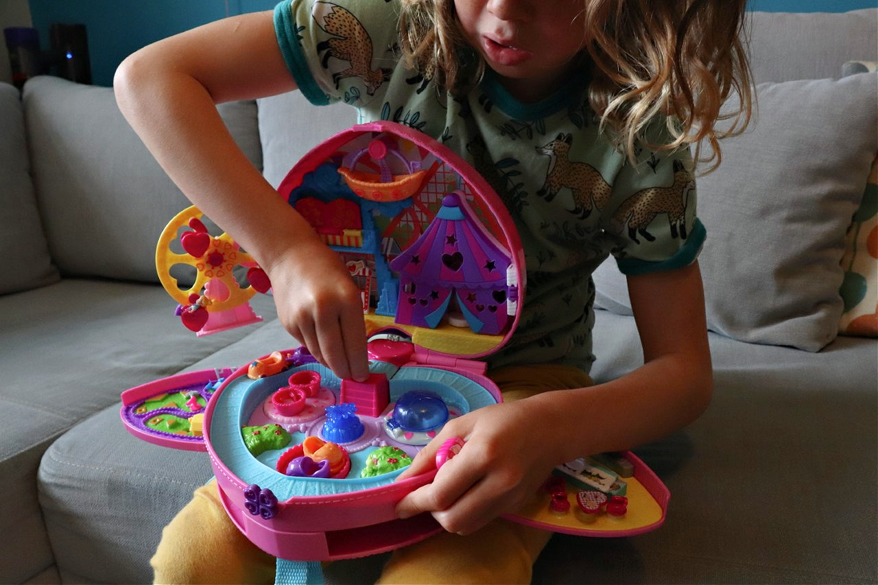 child playing with Polly pocket playset
