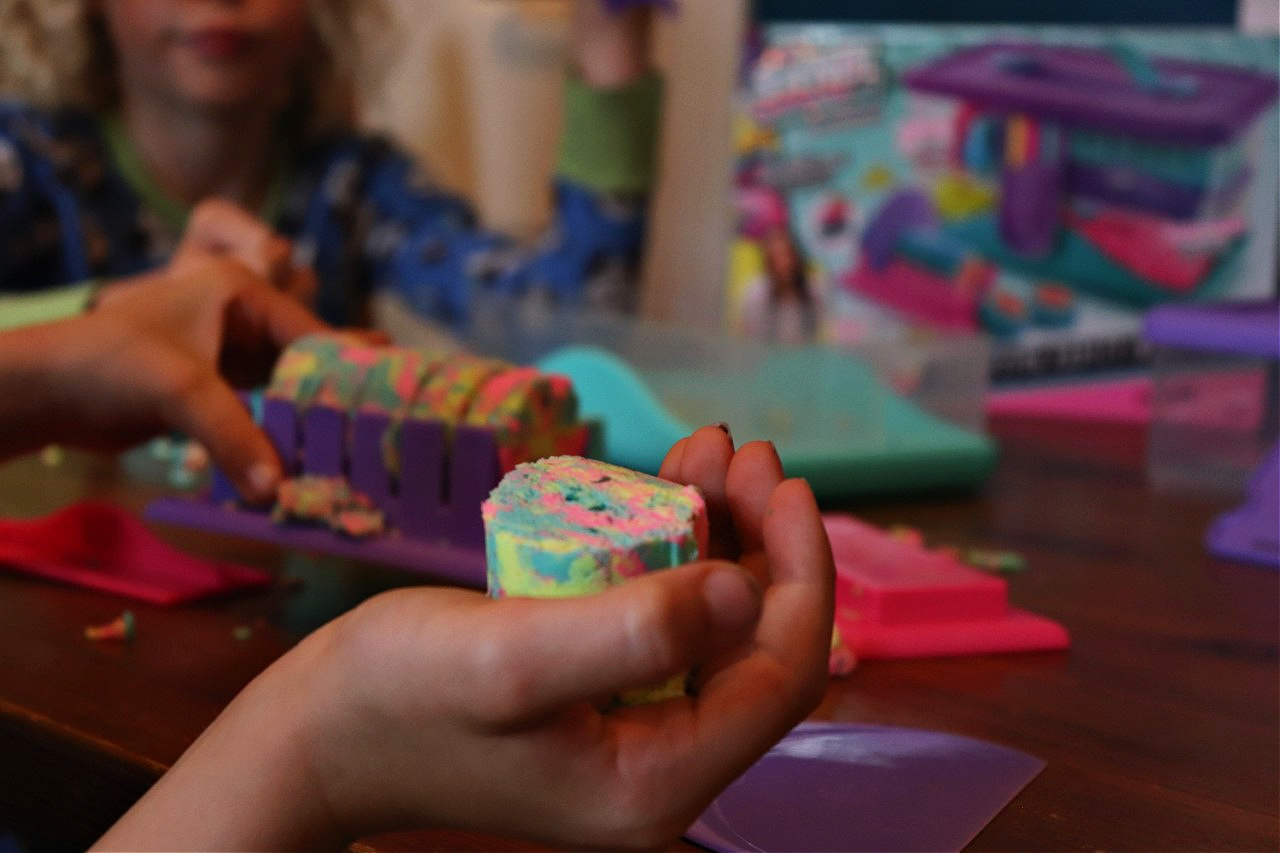children cutting up kinetic sand