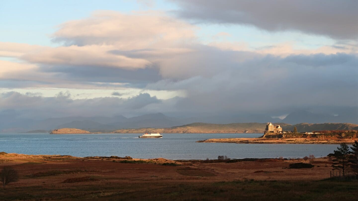 ferry sailing past Duart Castle on Isle of Mull