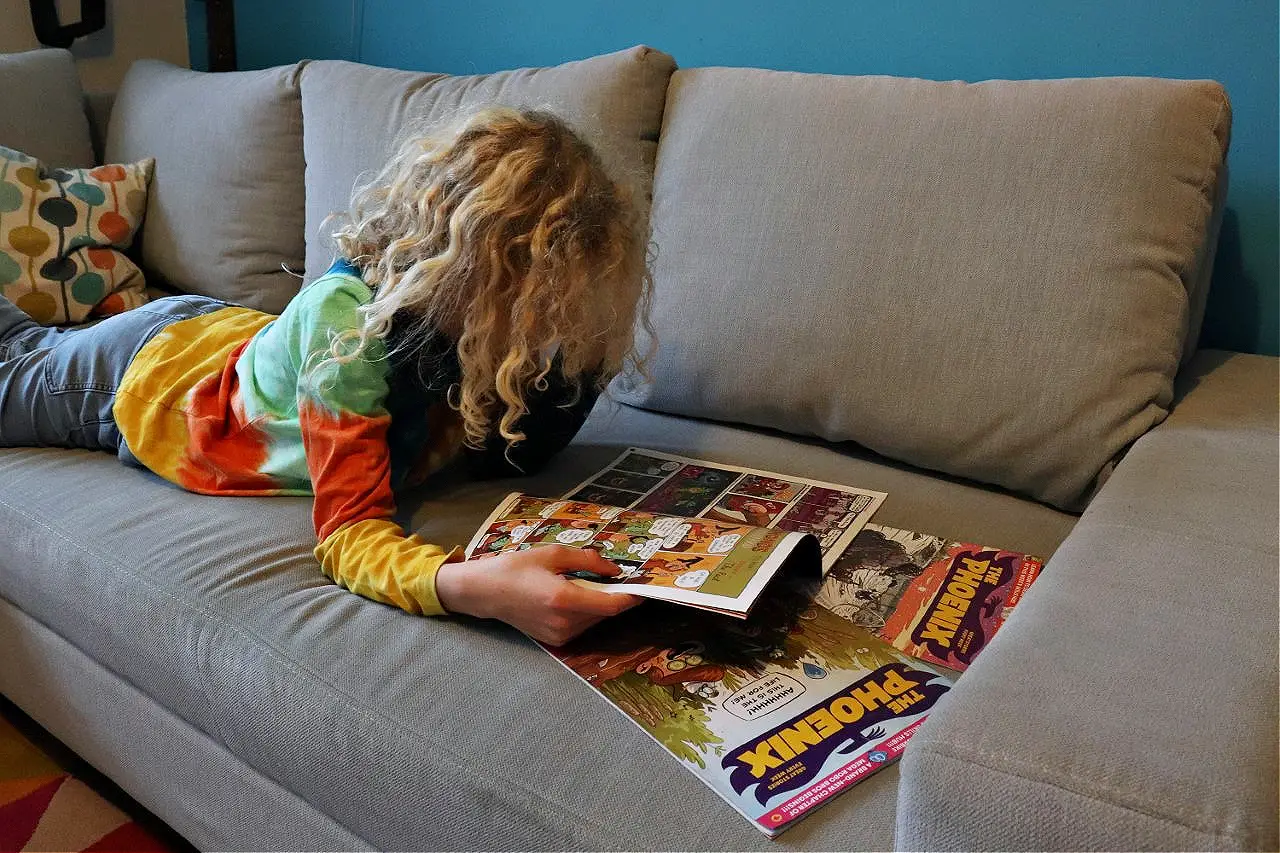 child reading Phoenix comics