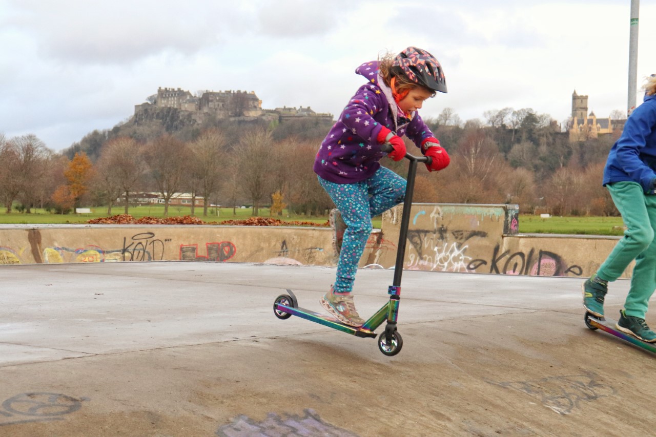 child on stunt scooter