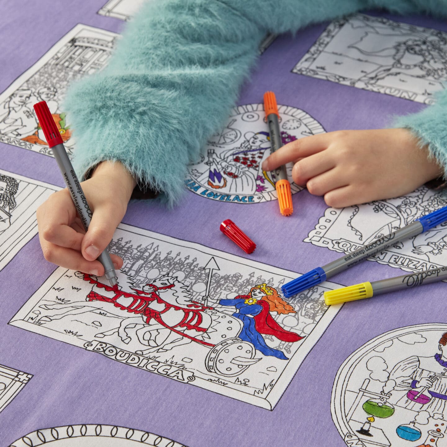 children colouring in a fabric tablecloth