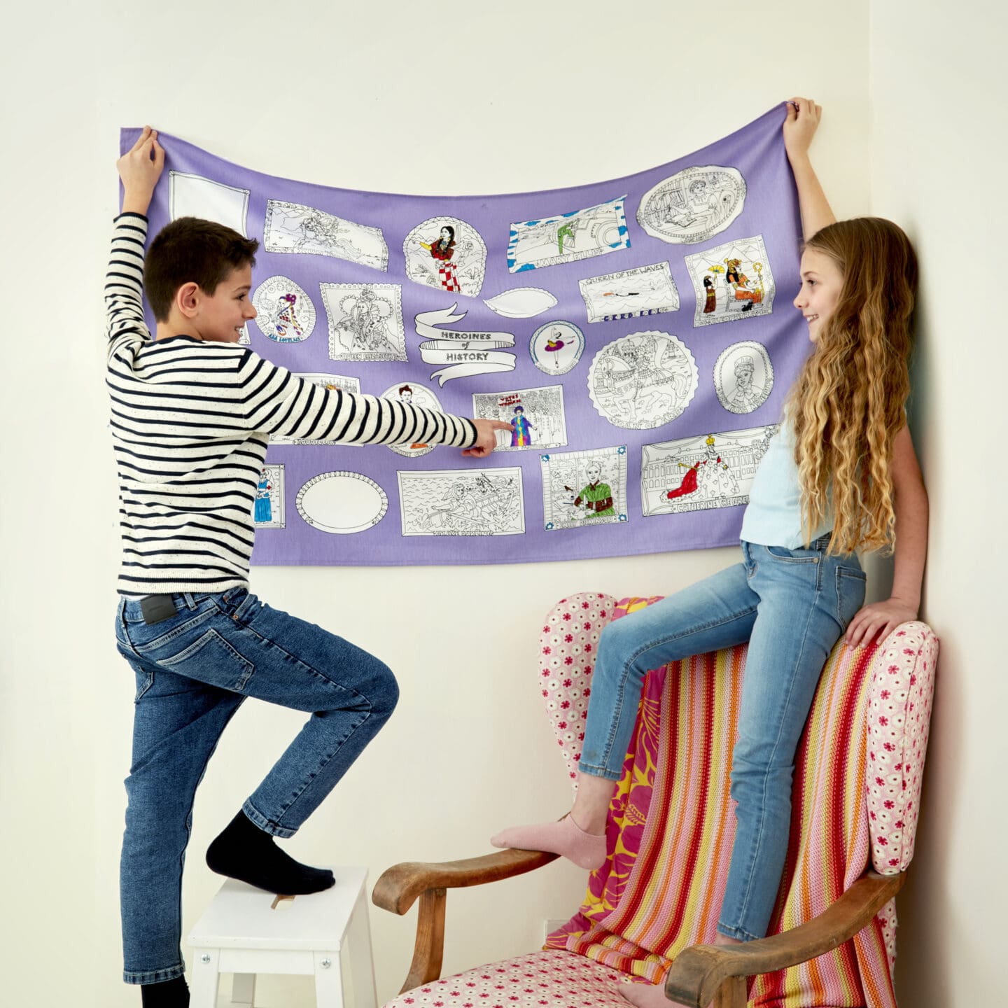children hanging up a large heroines of history cloth