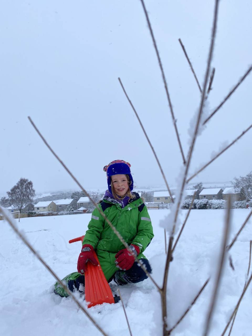 child with snow scooter