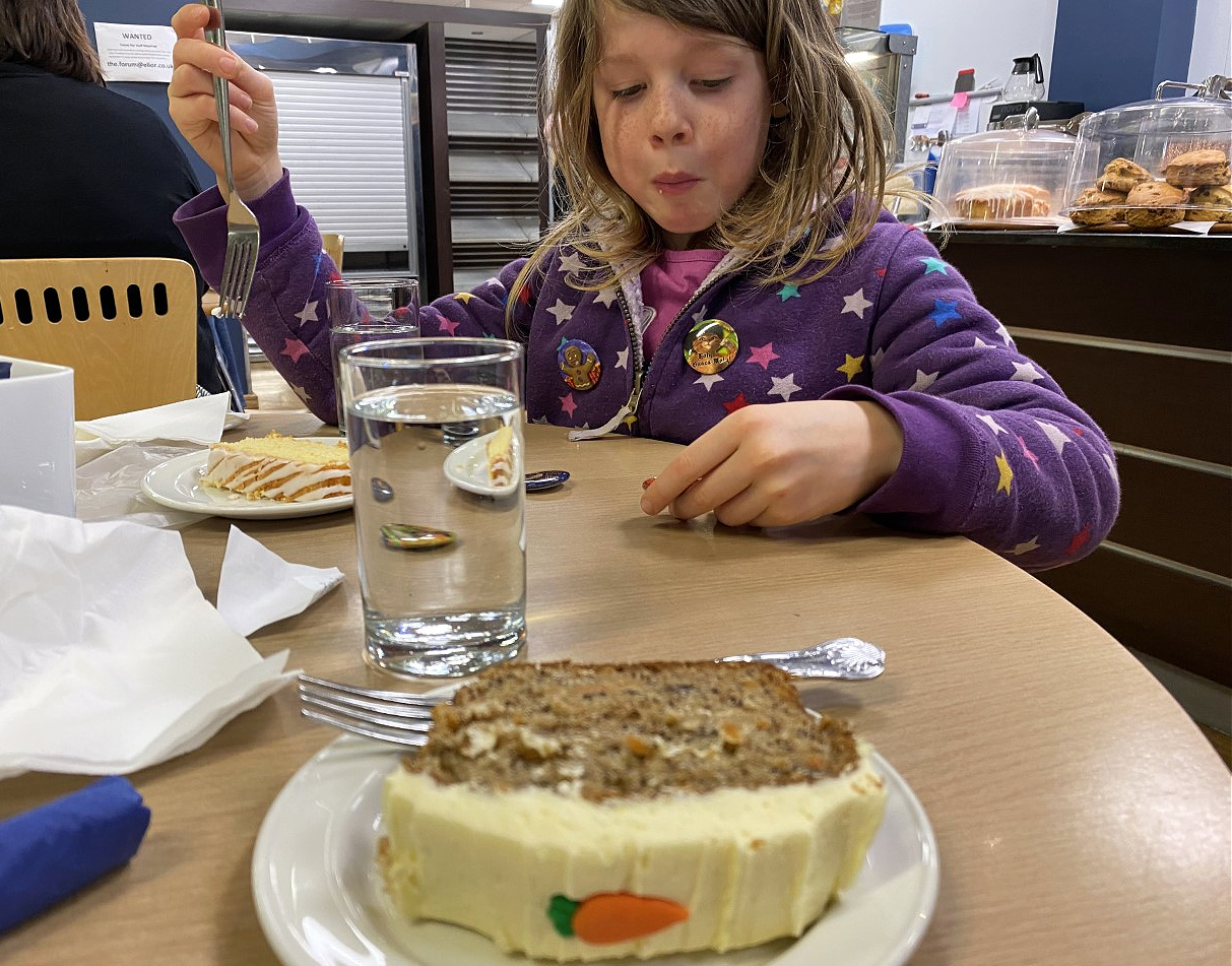 eating carrot cake at a cafe