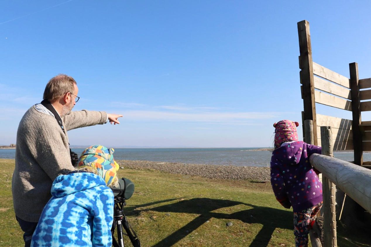Children watching seals through a telescope at South Walney Nature reserve