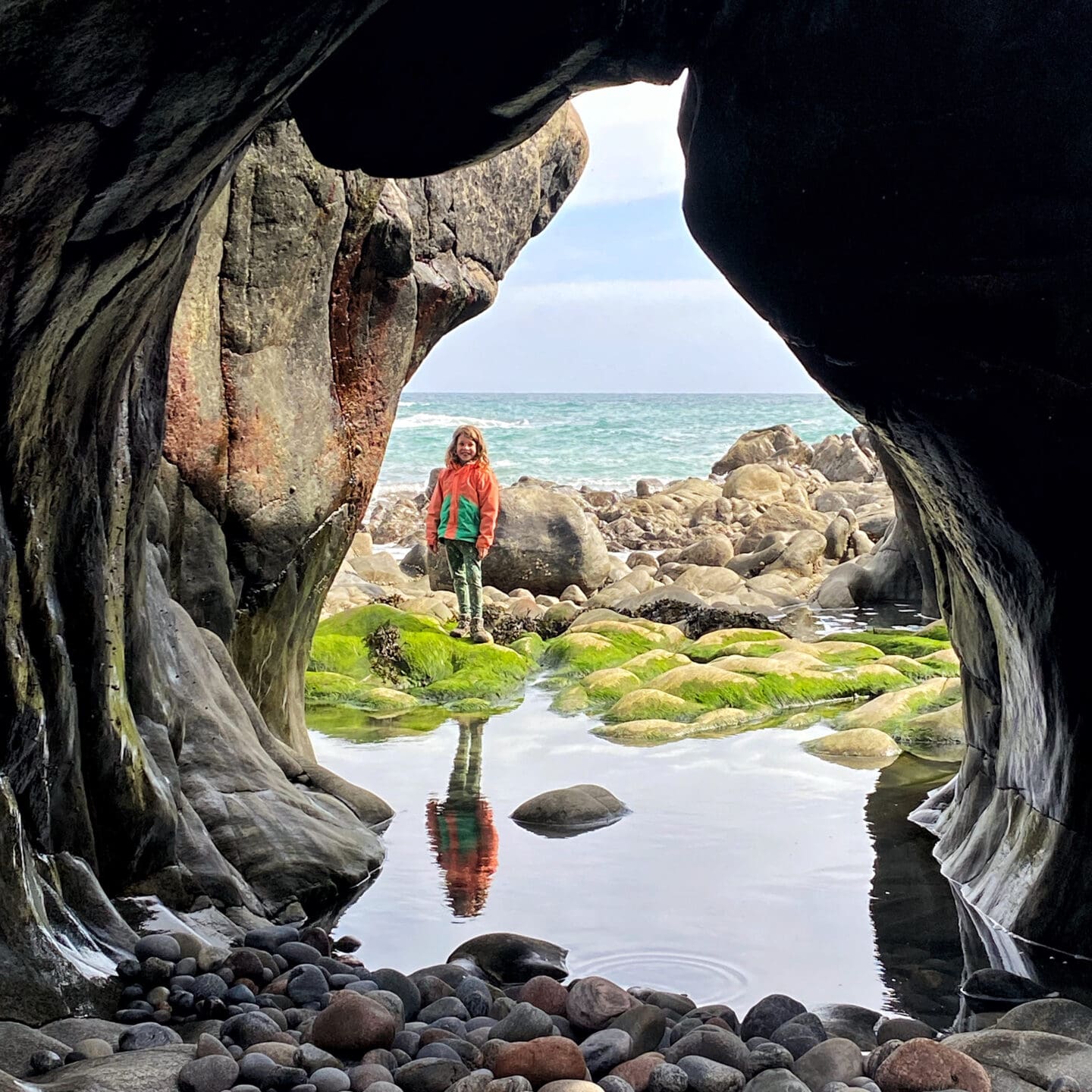Child under natural rock archway