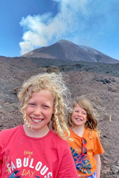Kids wearing bright t-shirts beside mt Etna