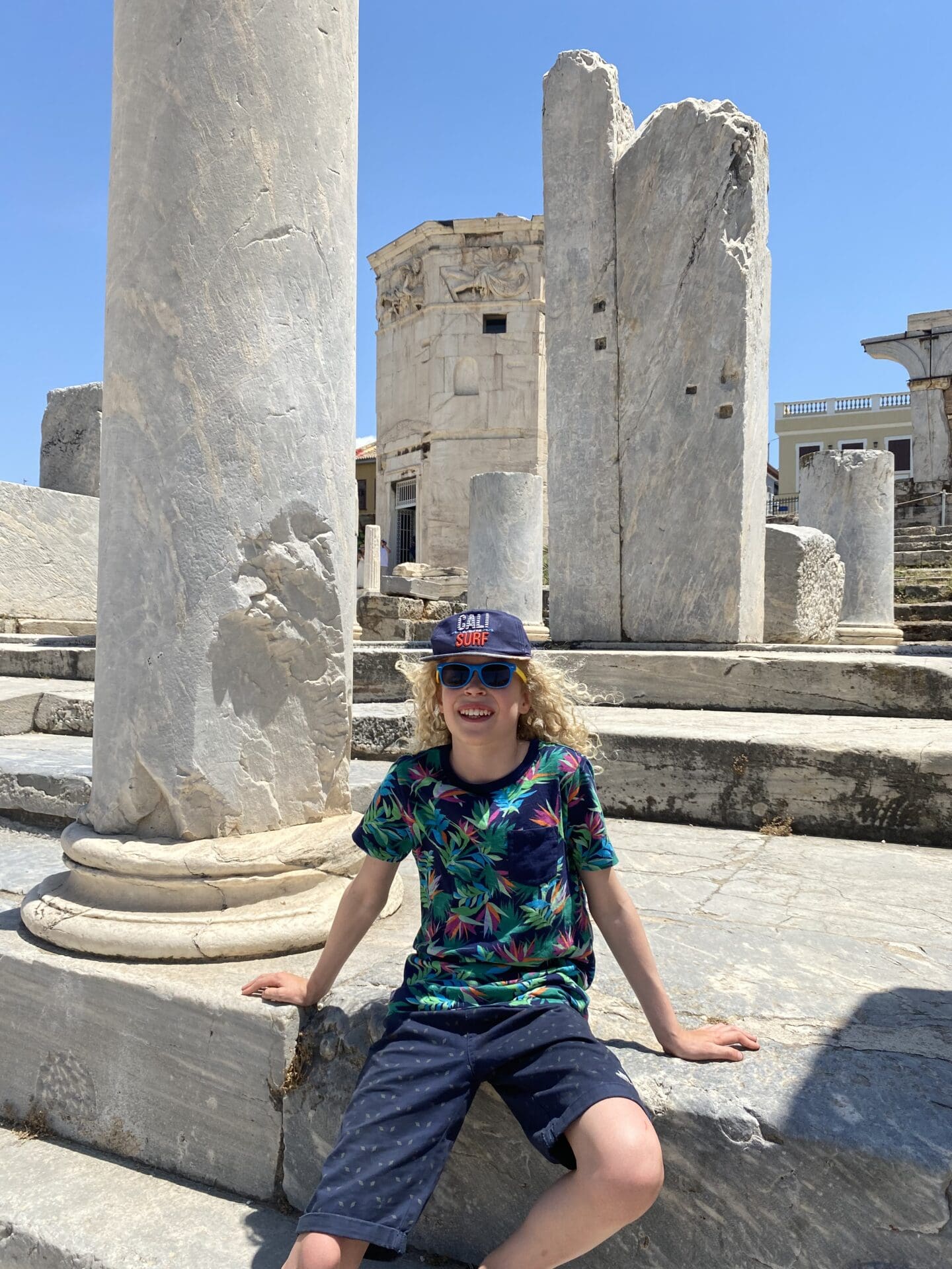 Child in front of tower of the winds Athens