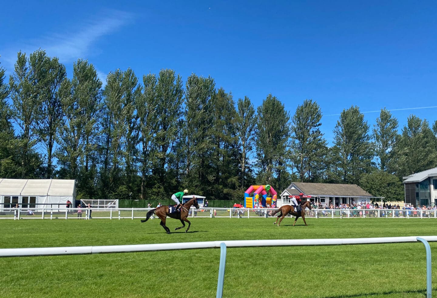 Horses and jockeys racing at Perth race course