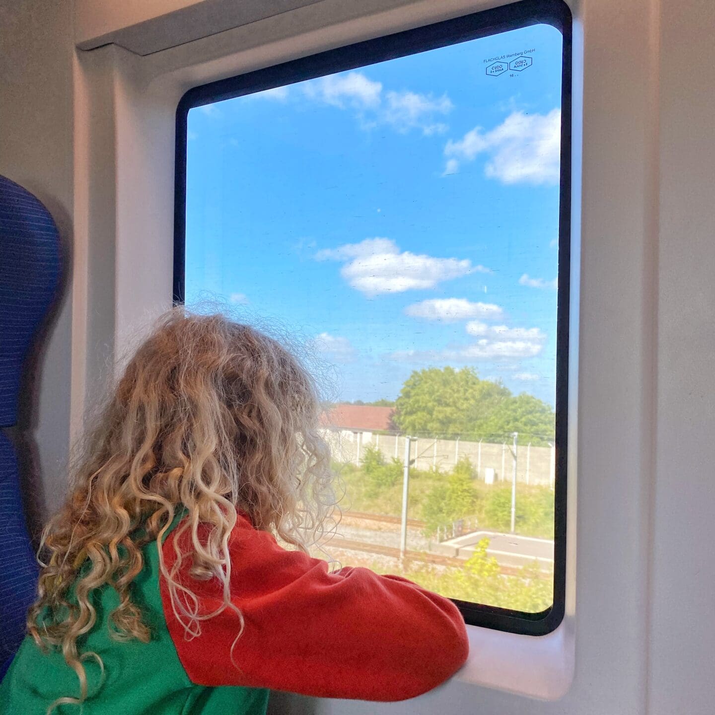 Child staring out train window